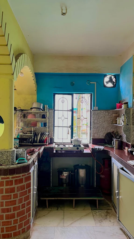 Kitchen with gas stove and utensils at Sharma PG Home, Siliguri