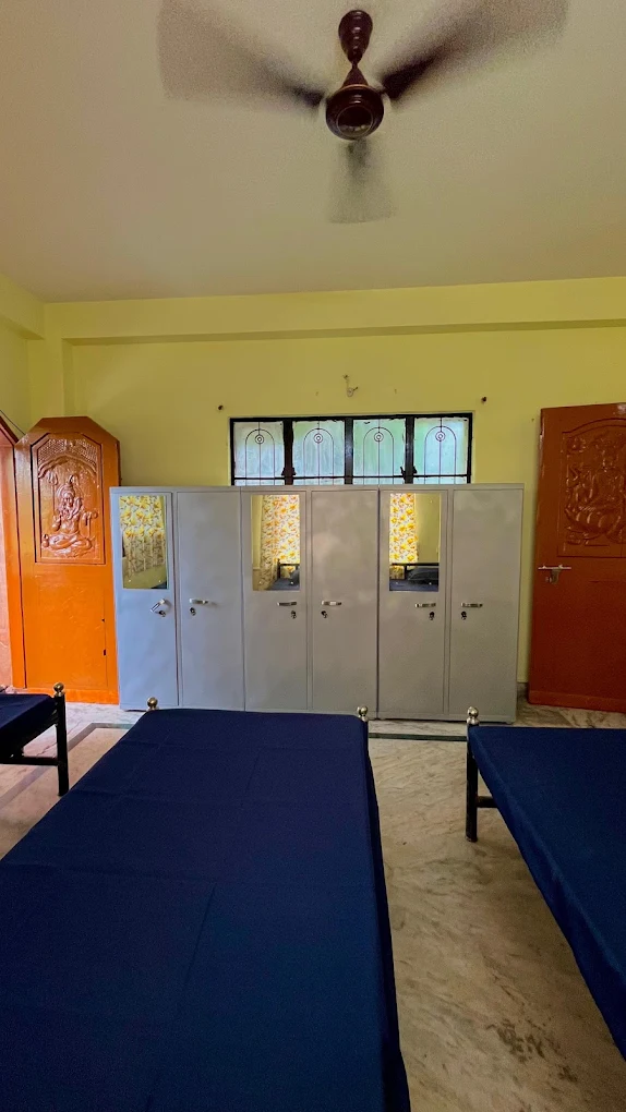 Sharma PG Home room in Siliguri with a row of storage wardrobes and beds
