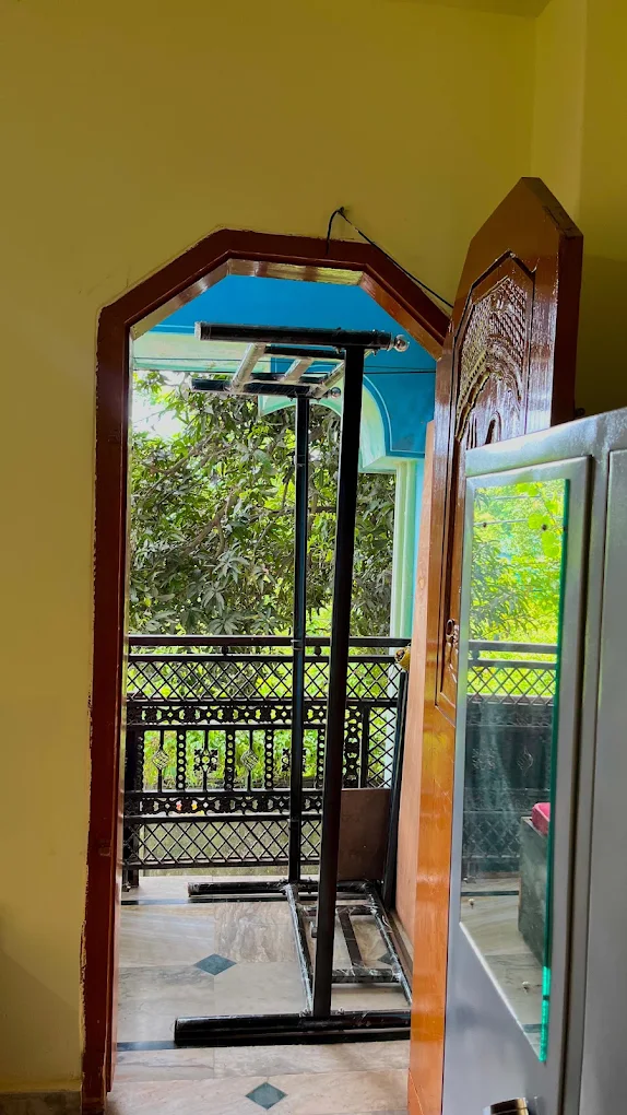 Balcony with drying space overlooking greenery at Sharma PG Home, Siliguri